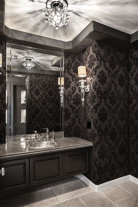 an elegant bathroom with black and white wallpaper, chandelier and