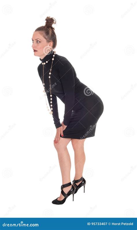 slim woman in a black dress bending stock image image of black gorgeous 95733407