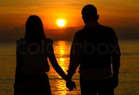Couple Of Lover Holding Hand With Sunrise Stock Photo Colourbox