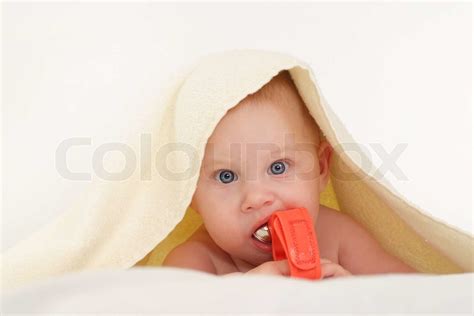 Baby Under Towel With Toy Stock Image Colourbox