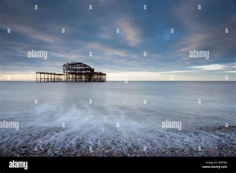 West Pier In Brighton At Dawn With Long Exposure Sea And Pink Stripes