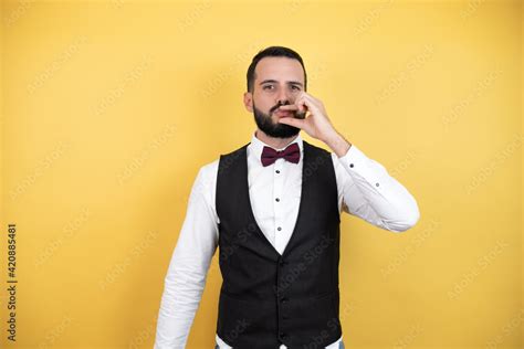 Babe Man With Beard Wearing Bow Tie And Vest With Mouth And Lips Shut As Zip With Fingers