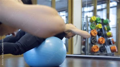 Female Trainer In The Gym Doing Hyperextension Relying On Fitball