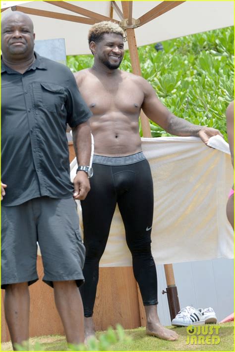 Full Sized Photo Of Usher Stays Clothed While Paddle Boarding Goes