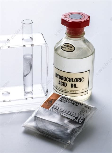 When hydrochloric acid reacts with magnesium metal, hydrogen gas and aqueous magnesium chloride are produced. Magnesium ribbon reacts with acid - Stock Image - A500 ...