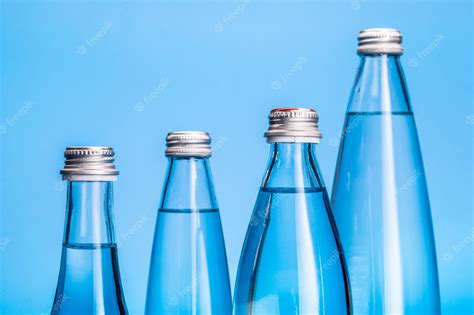 Premium Photo Glass Water Bottles On A Light Blue Background