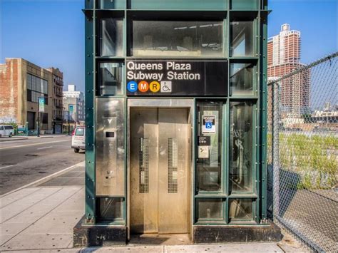 The Entrance To Queens Plaza Subway Station In New York City With An