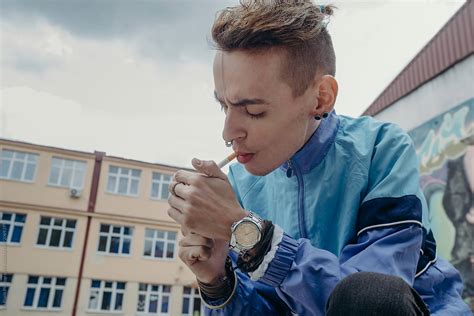 Portrait Of A Skinny Young Male Model With Autentic Style Smoking