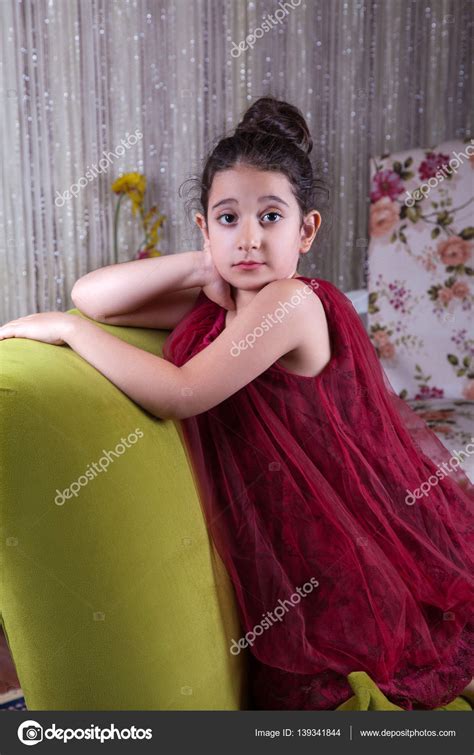 Cute Lovlely Middle Eastern Girl With Dark Red Dress And Collected Hair Posing And Liying On