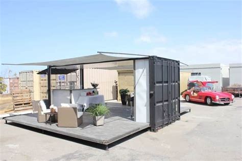 A Portable Home Made Out Of Shipping Containers In A Parking Lot Next