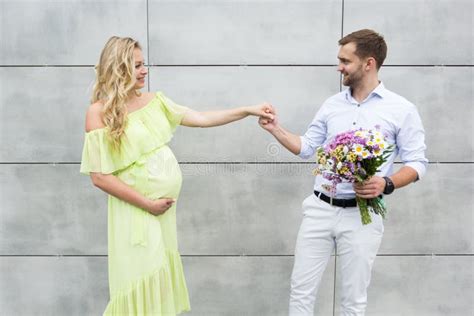 Young Couple In Love Holding Hands Looking At Each Other A Pregnant Wife Stock Image Image