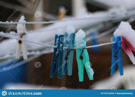 different colorful clothespins hang on the clothesline covered by snow stock image image of