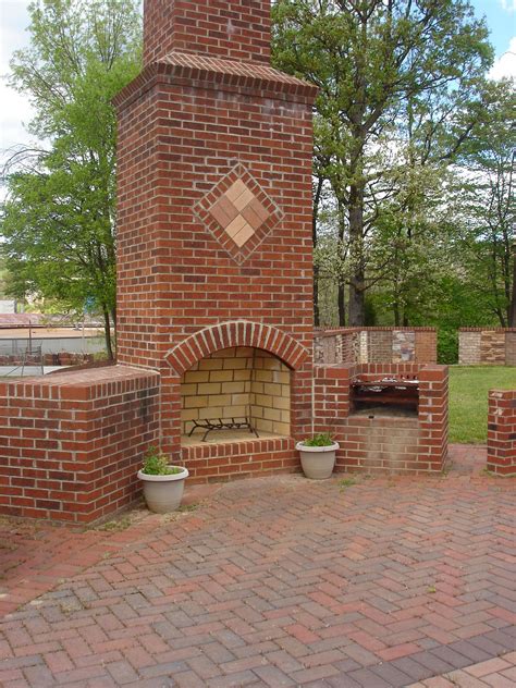 Clean the fireplace with a damp rag to remove cobwebs and dust. This classic red brick fireplace with decorative design on ...