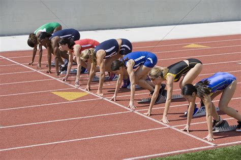 Female athletes in starting blocks ready to run Stock Photo - 1884172 ...