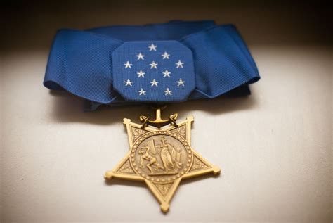 An Award Medal With A Blue Ribbon Around It And A Gold Star On The Front
