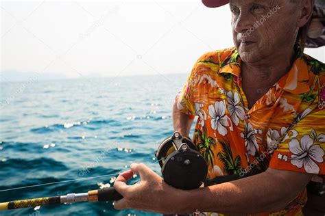 Mature Man Fishing In Tropical Sea Stock Photo By Mihtiander