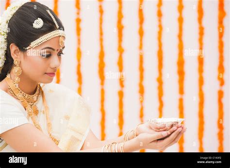 Bride In Traditional South Indian Dress Praying With A Oil Lamp Stock