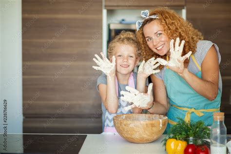 Happy Loving Caucasian Mom And Daughter Preparing Bakery Together