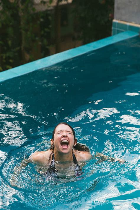 Woman In A Swimming Pool Laughing By Stocksy Contributor Laura