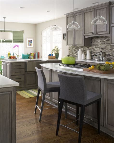 Grey glass kitchen backsplash with grey cabinets -- stone and pewter