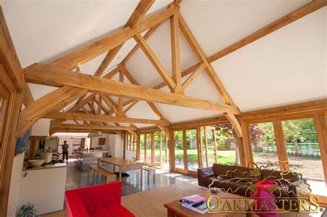 A vaulted ceiling angles up from the top plates of the wall sections. King Oak post trusses and open vaulted ceilings by ...