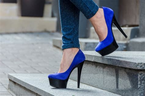 Beautiful Slender Female Legs In Tight Jeans And Blue Velvet High Heeled Shoes Stock Image