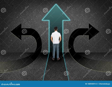 Man Standing At Crossroads Choice Between Different Ways Stock Photo