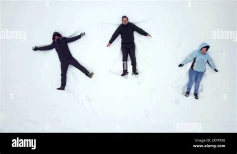 Making Snow Angels And Having Fun Stock Video Footage Alamy