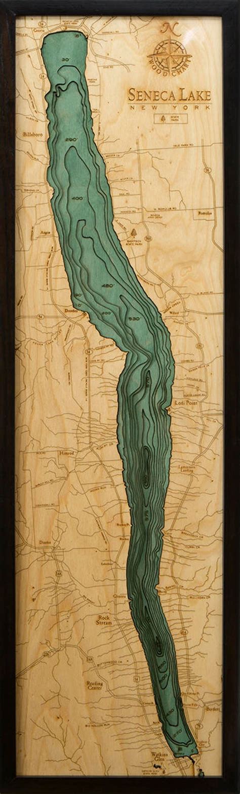 A Wooden Plaque With A Map Of The Lake And Mountains In Green On Its Side