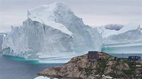 Huge Iceberg Threatens Greenland Village Bbc News