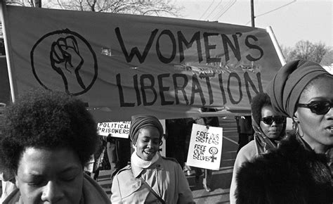 A Group Of Women Under A Womens Liberation Banner March In Support