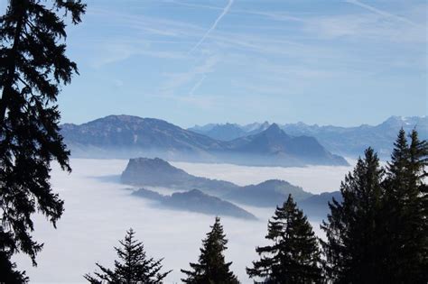 The Swiss Alpsfog Laying In The Mountains And Hiding The Lake