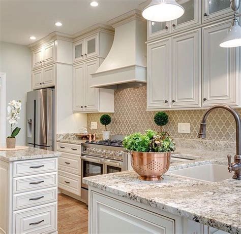 But it also serves as the decor focal point after your Elegant White Kitchen Cabinets Tan Backsplash | Kitchen ...