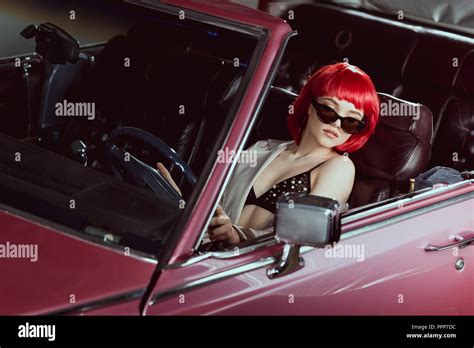 High Angle View Of Beautiful Girl In Bra And Sunglasses Driving Vintage