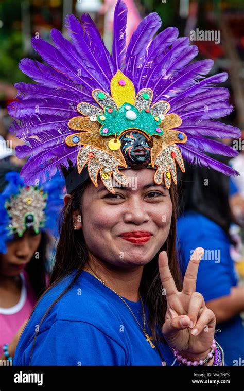 A Filipino Woman Takes Part In A Street Procession During The Ati