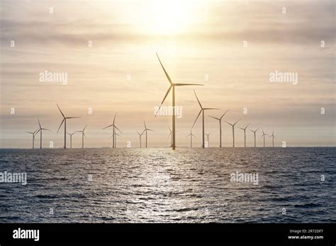 Offshore Windmill Farm Windmills Isolated At Sea On A Beautiful Bright