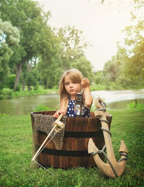 Child Pretending To Fish In Wooden Boat By Water Stock Image Image Of