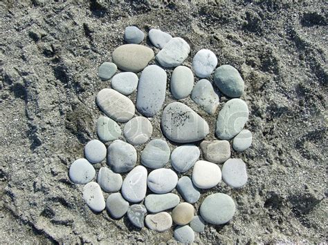 Pebbles On A Sand Beach Stock Photo Colourbox