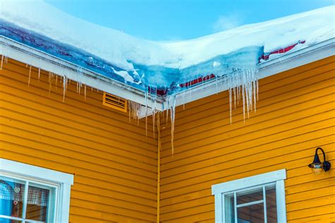 Frosty Sunny Day In The Arctic Icicles Hang From The Roof Of The House