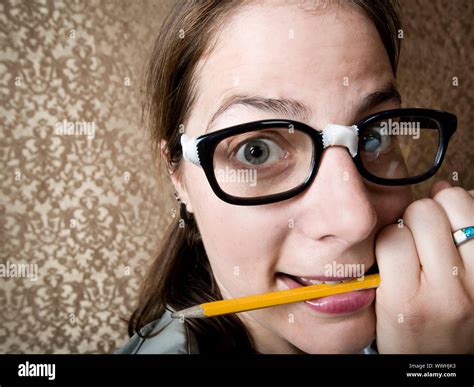 Nervous Nerdy Woman Chewing On A Yellow Pencil Stock Photo Alamy