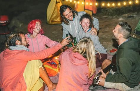 Group Of Friends Having Fun Cheering With Beers On The Beach With Tent At Night Stock Image