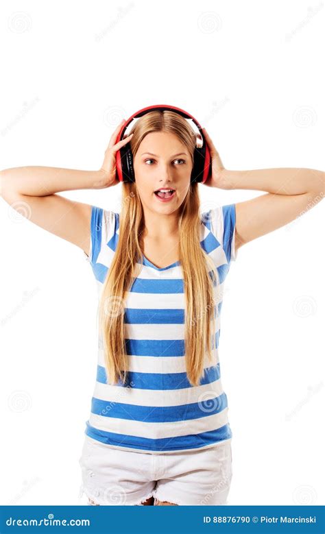 Young Woman With Headphones Listening And Singing To Music Isolated On