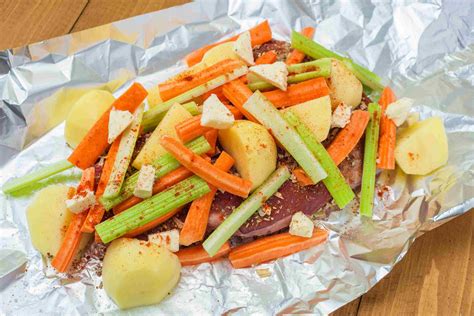 The beef chuck is baked in a foil package with potatoes, carrots, celery, and a surprise nostalgia ingredient: Budget Baked Chuck Steak Dinner in Foil | Recipe (With images) | Foil pack dinners, Chuck steak ...