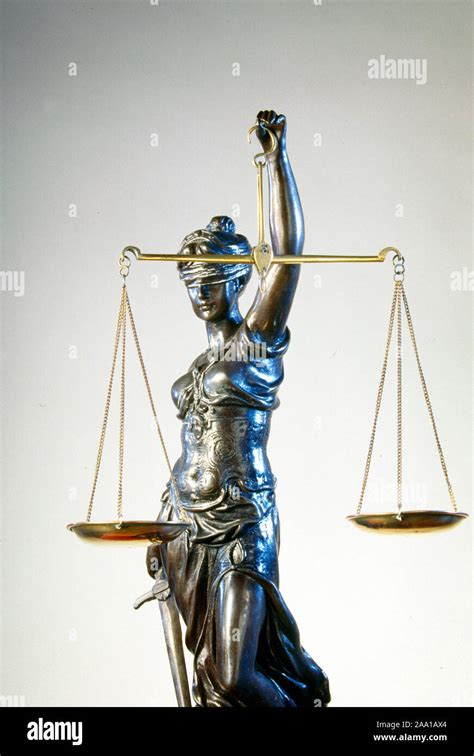 A Bronze Blind Justice Statue Holds A Pair Of Balance Scales Since The