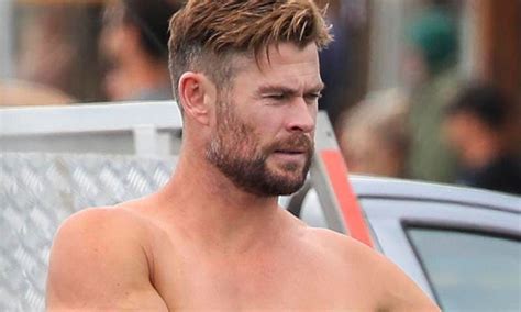 chris hemsworth shows off his incredible physique while surfing in byron bay