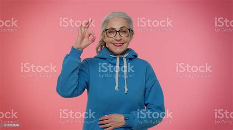 Mature Old Woman Looking Approvingly At Camera Showing Ok Gesture Like Sign Positive Something