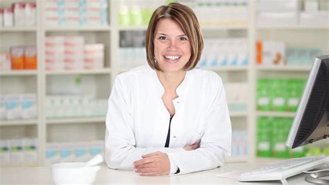 Young Female Pharmacist With Customer At Pharmacy Stock Footage Video