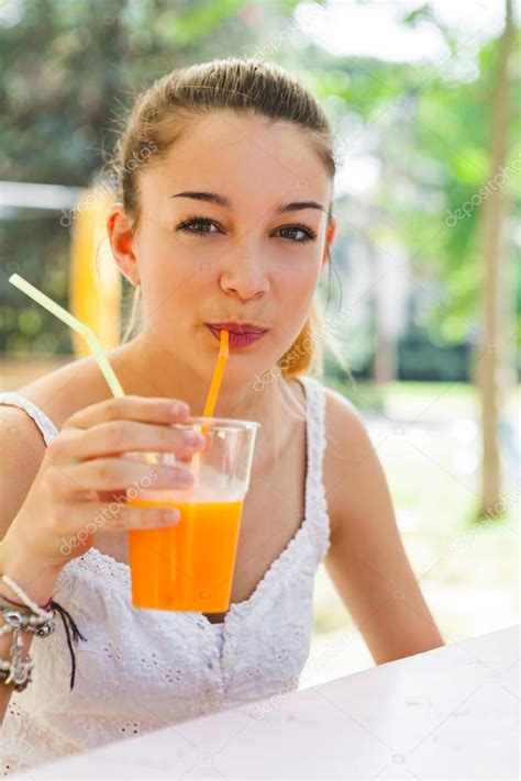 Pretty Girl Drinking Orange Juice — Stock Photo © Giorgiomagini 122927566