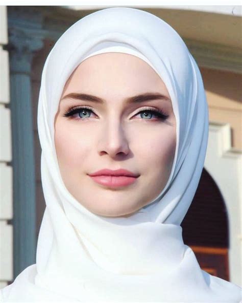 A Woman Wearing A Headscarf And Looking At The Camera
