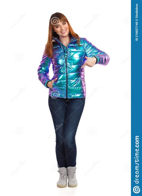Young Woman In Vibrant Down Jacket Is Pointing At Herself Stock Photo
